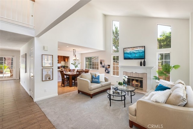 1188 Old Hickory Rd, Corona, CA 92882 - living area with a high ceiling, wood finished floors, and a glass covered fireplace