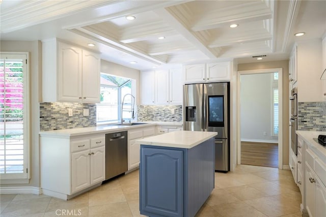20485 Via Canarias, Yorba Linda, CA 92887 - kitchen with appliances with stainless steel finishes, coffered ceiling, white cabinets, decorative backsplash, and a center island