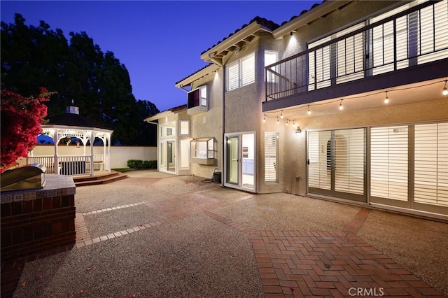 20485 Via Canarias, Yorba Linda, CA 92887 - patio at twilight featuring a balcony, a patio area, exterior kitchen, and a gazebo