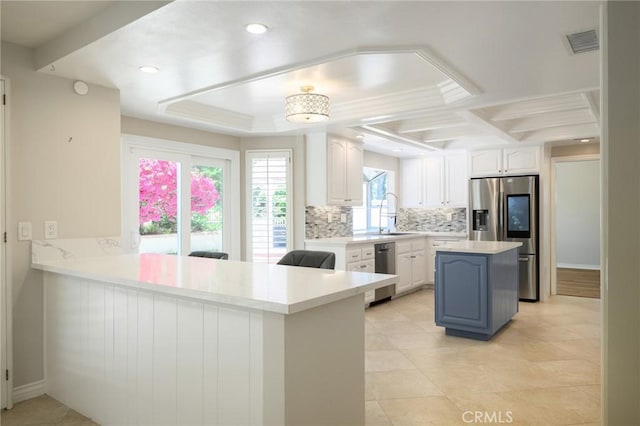 20485 Via Canarias, Yorba Linda, CA 92887 - kitchen featuring appliances with stainless steel finishes, backsplash, white cabinetry, light countertops, and a peninsula
