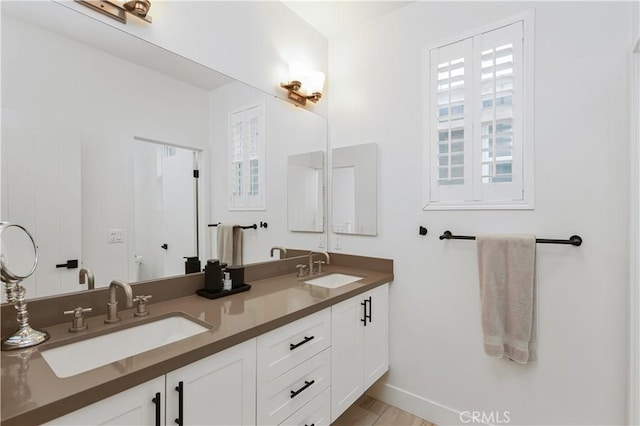 2294 Pacific Ave, Costa Mesa, CA 92627 - bathroom featuring double vanity, baseboards, and toilet