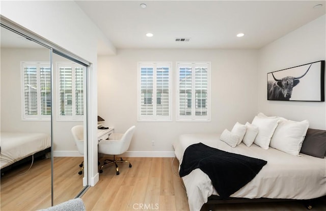 2294 Pacific Ave, Costa Mesa, CA 92627 - bedroom with a closet, multiple windows, baseboards, wood finished floors, and recessed lighting