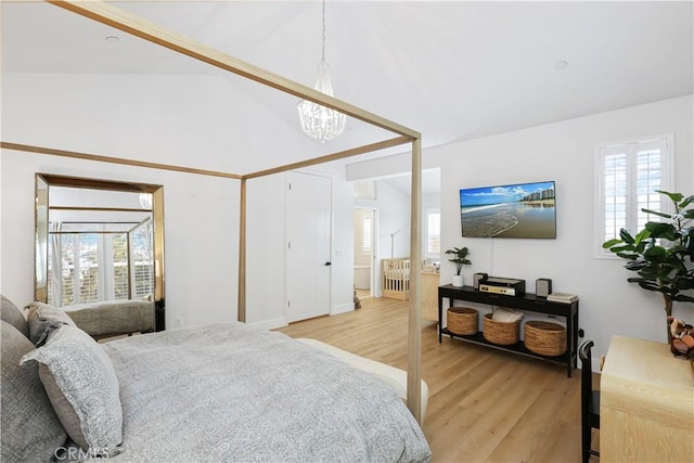 2294 Pacific Ave, Costa Mesa, CA 92627 - bedroom featuring light wood-type flooring, multiple windows, vaulted ceiling, and a chandelier
