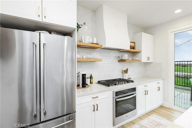 2294 Pacific Ave, Costa Mesa, CA 92627 - kitchen featuring appliances with stainless steel finishes, open shelves, light wood-type flooring, backsplash, and white cabinetry