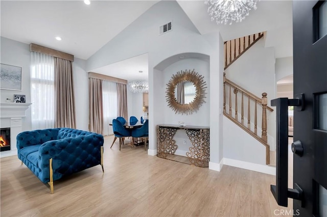 13909 Mountain View Pl, Sylmar, CA 91342 - foyer featuring a chandelier, stairway, wood finished floors, a lit fireplace, and baseboards