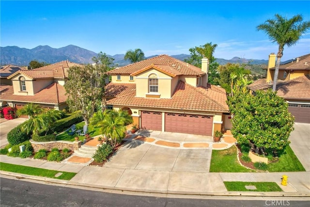 23848 Skyline, Mission Viejo, CA 92692 - mediterranean / spanish-style home with a tiled roof, stucco siding, a mountain view, and driveway