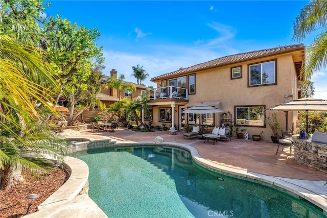 23848 Skyline, Mission Viejo, CA 92692 - rear view of property with a balcony, stucco siding, a patio, a pool with connected hot tub, and an outdoor kitchen