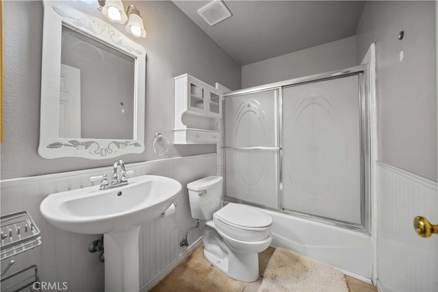 802 Duval St, La Verne, CA 91750 - full bath featuring enclosed tub / shower combo, toilet, a wainscoted wall, tile patterned flooring, and a sink
