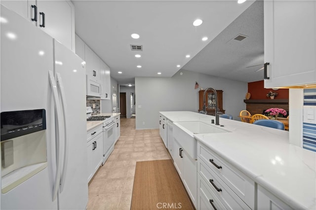 802 Duval St, La Verne, CA 91750 - kitchen with white appliances, a sink, white cabinetry, light countertops, and recessed lighting