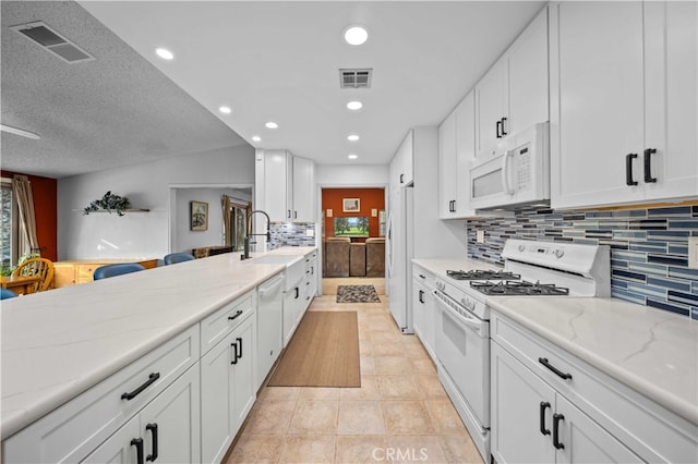 802 Duval St, La Verne, CA 91750 - kitchen with white appliances, a sink, white cabinets, light stone counters, and recessed lighting
