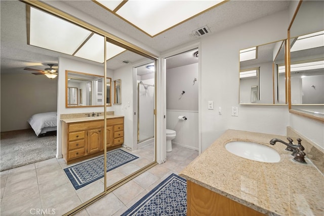 802 Duval St, La Verne, CA 91750 - ensuite bathroom featuring vanity, toilet, a shower stall, a ceiling fan, and a textured ceiling