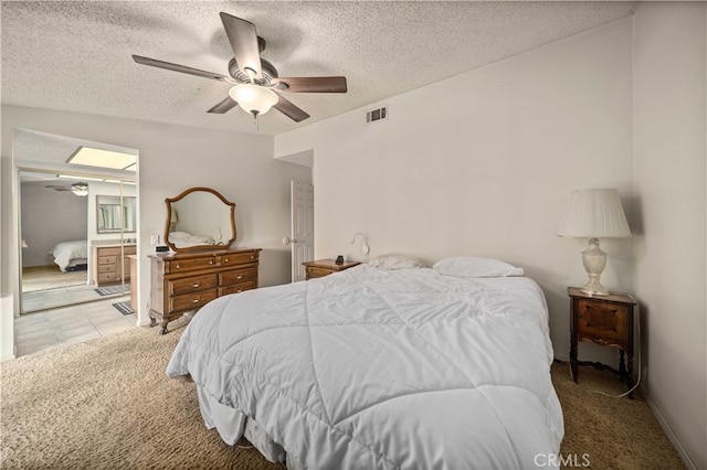 802 Duval St, La Verne, CA 91750 - carpeted bedroom with a textured ceiling, a ceiling fan, and connected bathroom