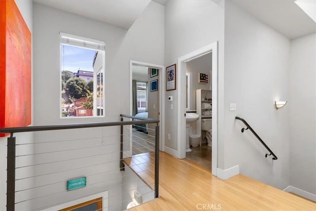 223 San Miguel St, Avila Beach, CA 93424 - hallway with an upstairs landing, wood finished floors, and baseboards