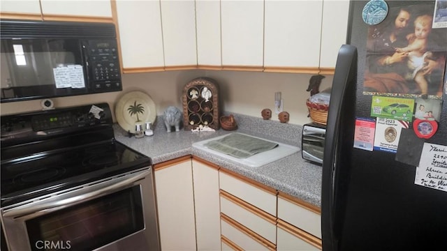 22907 Nadine Cir Unit B, Torrance, CA 90505 - kitchen featuring black appliances, white cabinetry, and light countertops