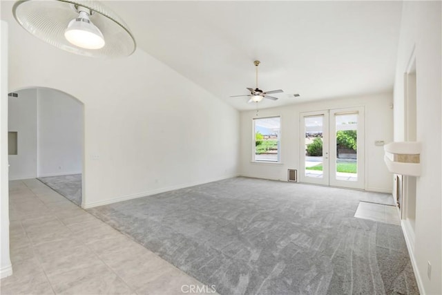 39654 Bordeaux Pl, Murrieta, CA 92562 - unfurnished living room with a ceiling fan, arched walkways, carpet flooring, baseboards, and lofted ceiling
