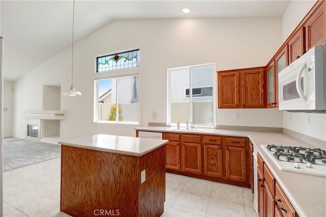 39654 Bordeaux Pl, Murrieta, CA 92562 - kitchen with white appliances, high vaulted ceiling, light tile patterned floors, light countertops, and brown cabinets