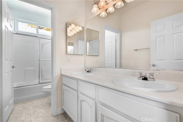39654 Bordeaux Pl, Murrieta, CA 92562 - bathroom featuring toilet, double vanity, tile patterned floors, enclosed tub / shower combo, and a chandelier