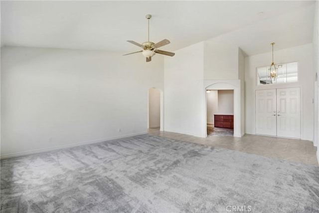 39654 Bordeaux Pl, Murrieta, CA 92562 - unfurnished living room with arched walkways, carpet floors, a chandelier, high vaulted ceiling, and a ceiling fan