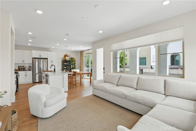 3590 E Peckham Paseo Unit 6, Ontario, CA 91761 - living room with light wood-style floors and recessed lighting