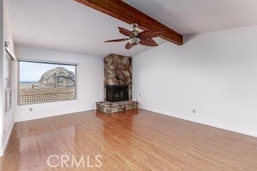 965 Morro Ave Unit D, Morro Bay, CA 93442 - unfurnished living room featuring wood finished floors, ceiling fan, and a stone fireplace