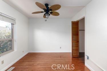 965 Morro Ave Unit D, Morro Bay, CA 93442 - unfurnished bedroom featuring wood finished floors, baseboards, and ceiling fan