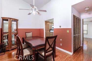 965 Morro Ave Unit D, Morro Bay, CA 93442 - dining area with ceiling fan, wood finished floors, and high vaulted ceiling