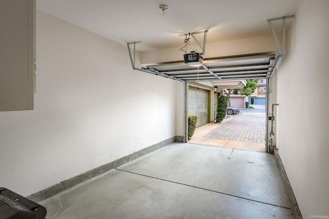 36 Via Sovana, Santee, CA 92071 - garage featuring a garage door opener, baseboards, and electric panel