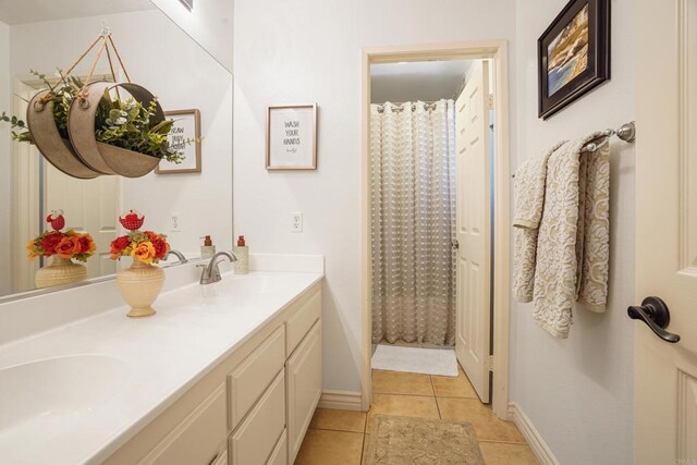 8749 Fairoaks Ct, Rancho Cucamonga, CA 91730 - bathroom with tile patterned floors, double vanity, baseboards, and curtained shower