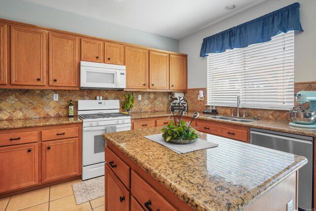 8749 Fairoaks Ct, Rancho Cucamonga, CA 91730 - kitchen featuring white appliances, a sink, brown cabinetry, a kitchen island, and tasteful backsplash