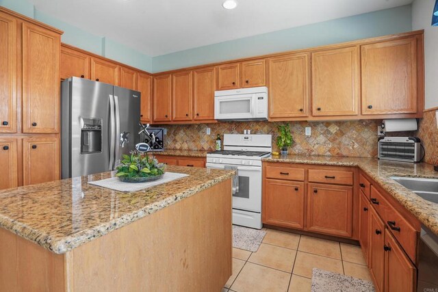 8749 Fairoaks Ct, Rancho Cucamonga, CA 91730 - kitchen with white appliances, light stone counters, backsplash, and recessed lighting