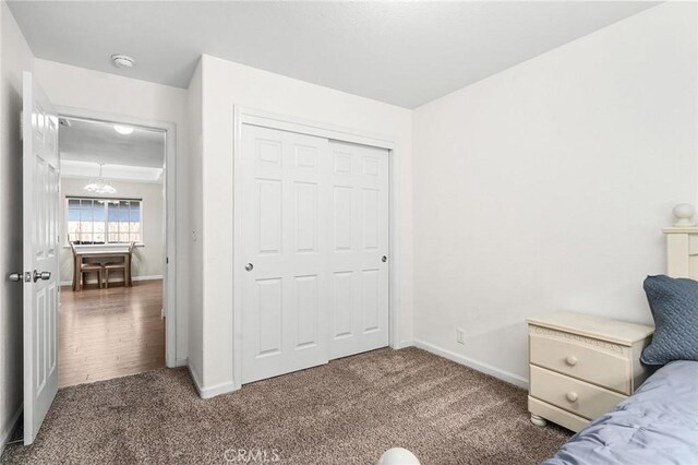 1377 Lucy Way, Chico, CA 95973 - carpeted bedroom with baseboards, a closet, and a chandelier
