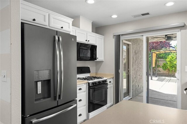 1377 Lucy Way, Chico, CA 95973 - kitchen featuring stainless steel fridge, black microwave, range with gas cooktop, light countertops, and white cabinets