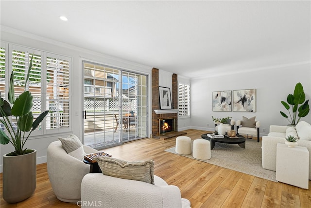 431 Cranston Ct Unit 102, Long Beach, CA 90803 - living area with crown molding, light wood-style floors, and a brick fireplace