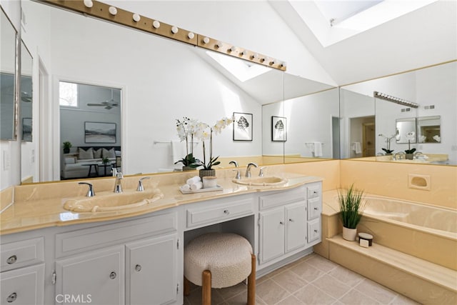 431 Cranston Ct Unit 102, Long Beach, CA 90803 - full bathroom featuring a skylight, double vanity, a garden tub, tile patterned floors, and high vaulted ceiling