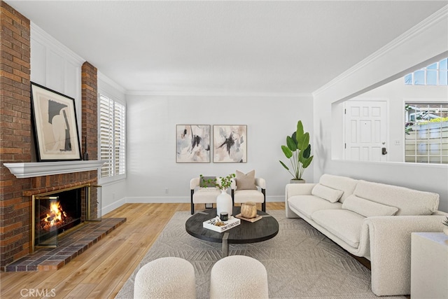 431 Cranston Ct Unit 102, Long Beach, CA 90803 - living area with light wood-type flooring, healthy amount of natural light, crown molding, and a brick fireplace