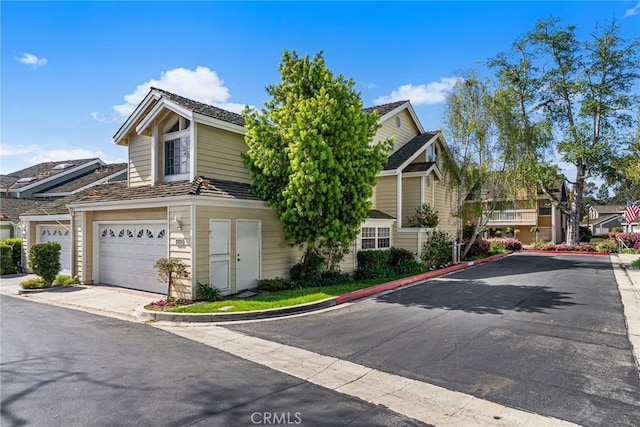431 Cranston Ct Unit 102, Long Beach, CA 90803 - view of front of house with concrete driveway, an attached garage, and a residential view