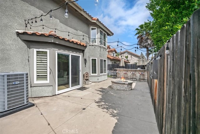 27692 Motherlode Ct, Laguna Niguel, CA 92677 - back of property featuring a fire pit, stucco siding, a patio area, a fenced backyard, and a tiled roof