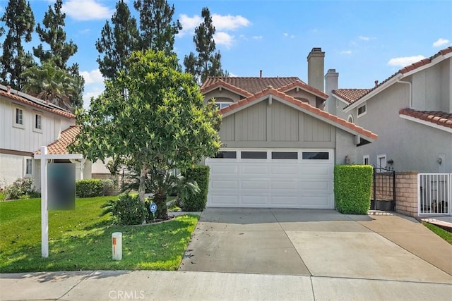 27692 Motherlode Ct, Laguna Niguel, CA 92677 - view of front facade featuring a garage, a tiled roof, driveway, board and batten siding, and stucco siding