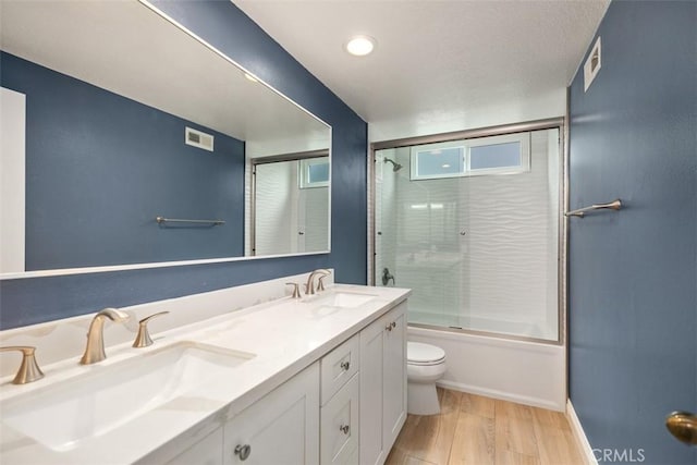 27692 Motherlode Ct, Laguna Niguel, CA 92677 - full bathroom with double vanity, wood finished floors, and combined bath / shower with glass door