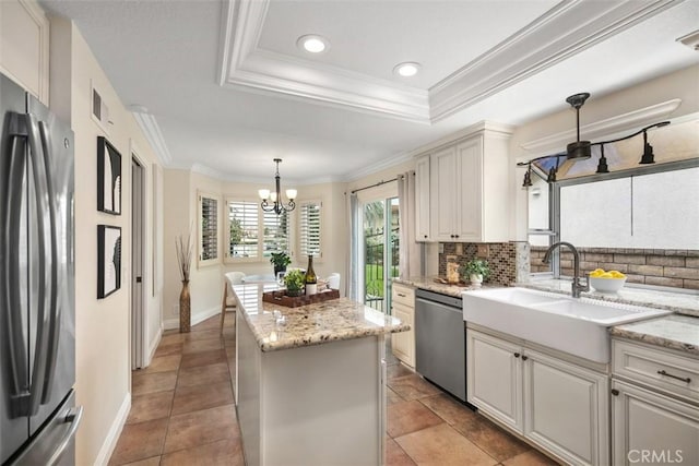 27692 Motherlode Ct, Laguna Niguel, CA 92677 - kitchen featuring stainless steel appliances, a kitchen island, tasteful backsplash, a chandelier, and ornamental molding