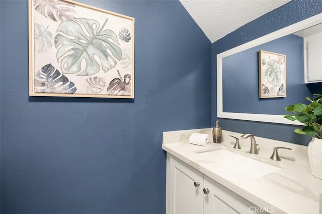 27692 Motherlode Ct, Laguna Niguel, CA 92677 - bathroom featuring vaulted ceiling, vanity, a textured ceiling, and a textured wall