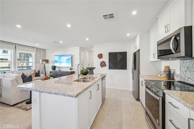 16183 Lumia Way, Fontana, CA 92336 - kitchen featuring stainless steel appliances, a sink, recessed lighting, white cabinets, and a center island with sink