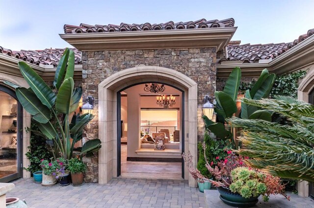 7133 Obelisco Cir, Carlsbad, CA 92009 - doorway to property with stone siding and a tile roof