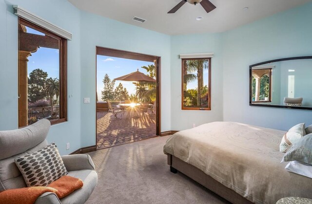 7133 Obelisco Cir, Carlsbad, CA 92009 - carpeted bedroom featuring access to outside, multiple windows, a ceiling fan, and baseboards