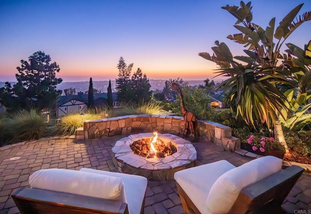 7133 Obelisco Cir, Carlsbad, CA 92009 - patio terrace at dusk featuring a patio and a fire pit