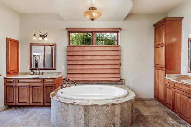7133 Obelisco Cir, Carlsbad, CA 92009 - full bathroom featuring stone tile flooring, two vanities, and a bath