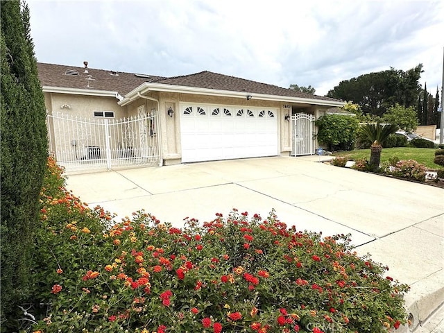 19401 Twin Hills Pl, Porter Ranch, CA 91326 - view of property exterior featuring driveway, an attached garage, stucco siding, and a gate