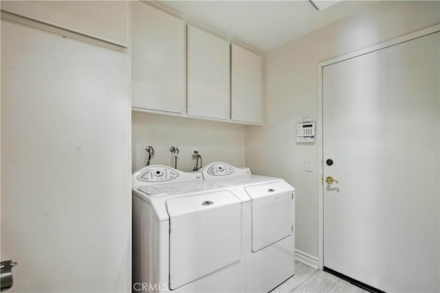 19401 Twin Hills Pl, Porter Ranch, CA 91326 - washroom with washer and clothes dryer, cabinet space, and light wood finished floors