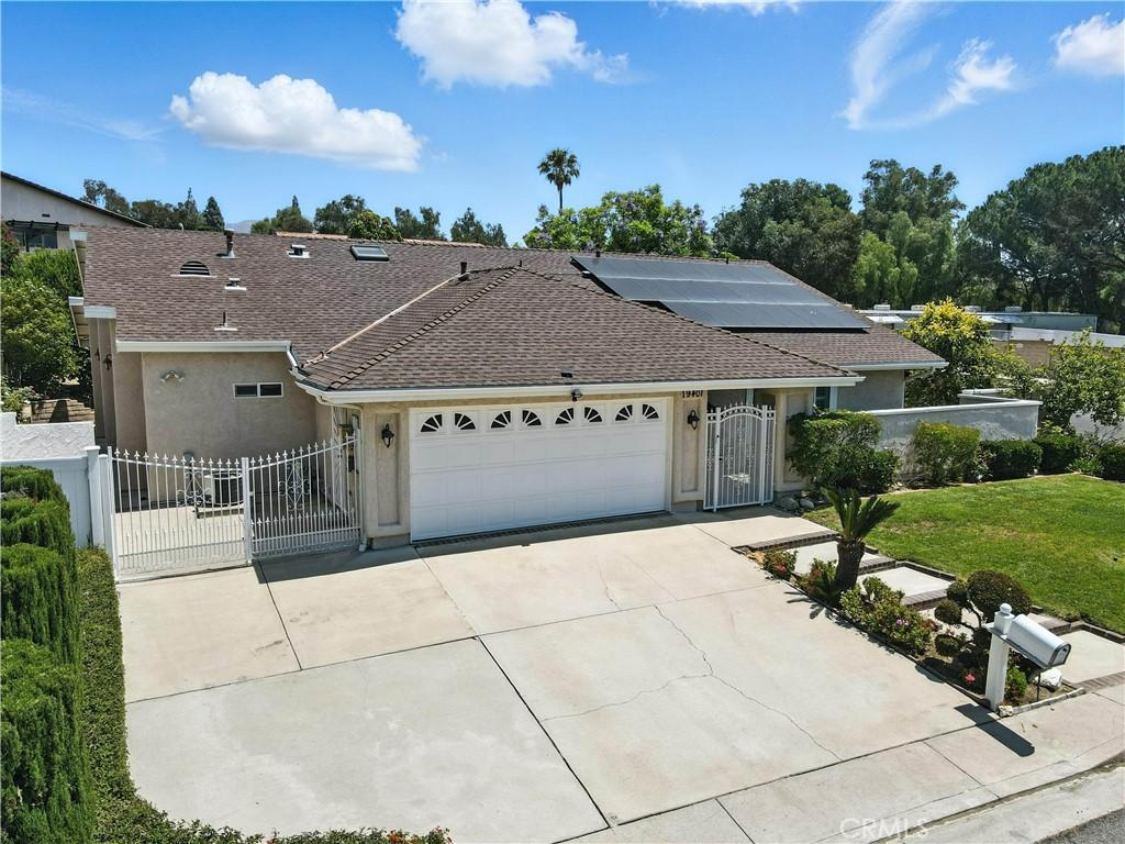19401 Twin Hills Pl, Porter Ranch, CA 91326 - single story home featuring a gate, stucco siding, an attached garage, a shingled roof, and concrete driveway