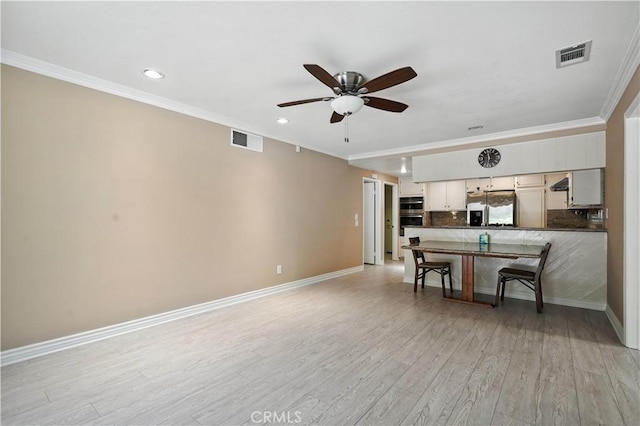 19401 Twin Hills Pl, Porter Ranch, CA 91326 - kitchen with appliances with stainless steel finishes, dark countertops, light wood finished floors, a ceiling fan, and ornamental molding